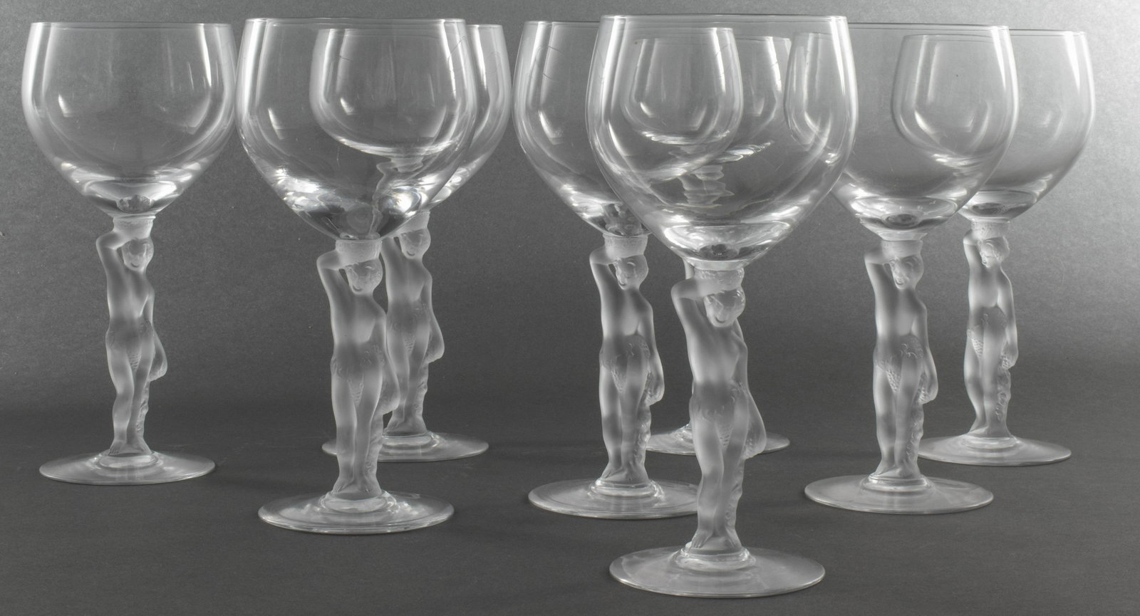 Lalique Style Crystal Wine Glasses, 8 PCS: Set of 8 Lalique style clear crystal wine glasses with frosted figural stems, 7" H x 3.25" diameter.
