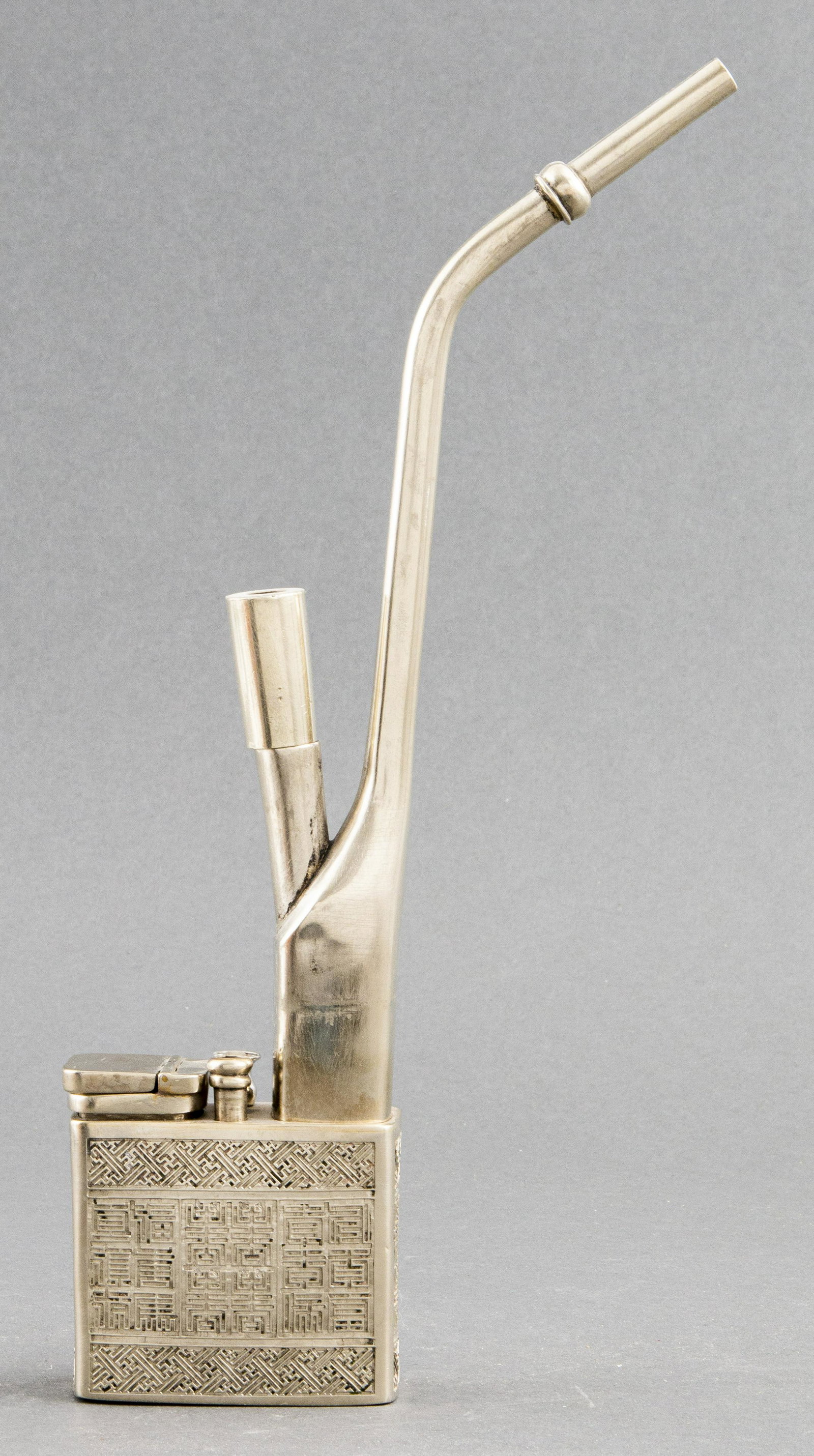 Chinese Paktong Engraved Water Pipe: Chinese Paktong water / opium pipe with engraved decoration, early 20th century, signed underside hinged lid with Chinese characters. 12.75" H x 3" W x 1.5" D.