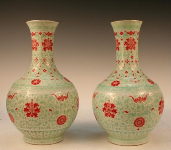 Pair Qing Chinese Qianlong Doucai Porcelain Vases: Pair of long-necked vases with hand-painted overglaze doucai decoration of foliage and bats, China, Qing Dynasty (1644-1911); Qianlong mark on bottom. Dimensions: Each 14-1/4"H x 8-1/4"diameter