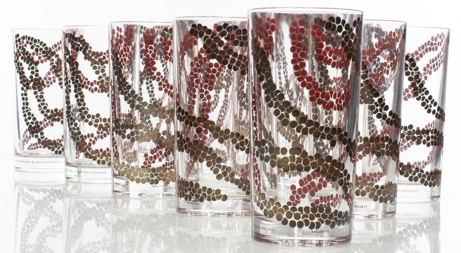 Nathalie Jean for Sottsass Argento Glasses, 12: Set of 12 Nathalie Jean design for Sottsass Associati 'Argento' highball cocktail glasses, each hand decorated with red enamel overlaid 980/1000 silver dots, bases marked Egizia. 5.75” H x 3” diam
