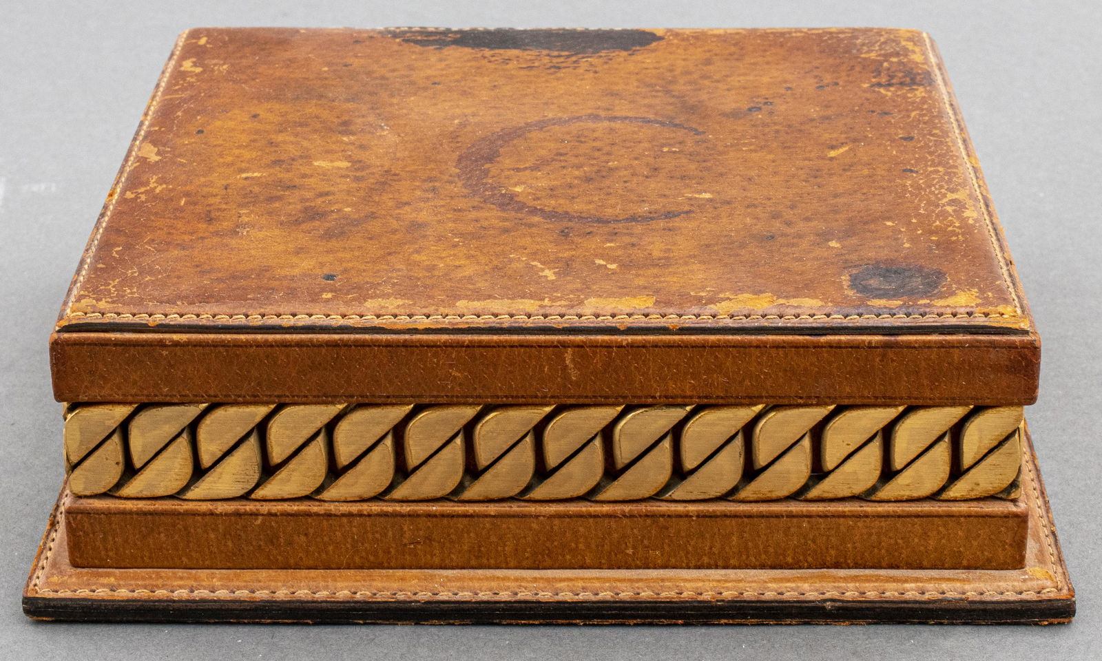 Gucci Italy Leather Dresser / Jewelry Box: Leather dresser / jewelry box with wooden insert and gold tone metal accents, stamped to underside: "Made in Italy by Gucci," 2.75" H x 8.5" W x 8.25" D. Signs of wear and marks noted.
