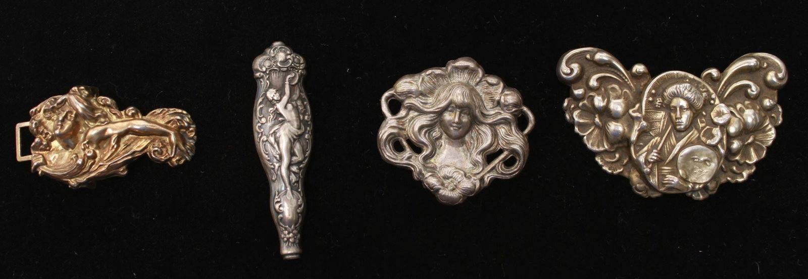 Art Nouveau Silver Buckle, Handle & 2 Brooches: Group of four Art Nouveau pieces, comprising a repousse silver gilt vermeil belt buckle depicting a woman with an extended arm, a silver handle with a dancing nude woman with a tambourine, and two met