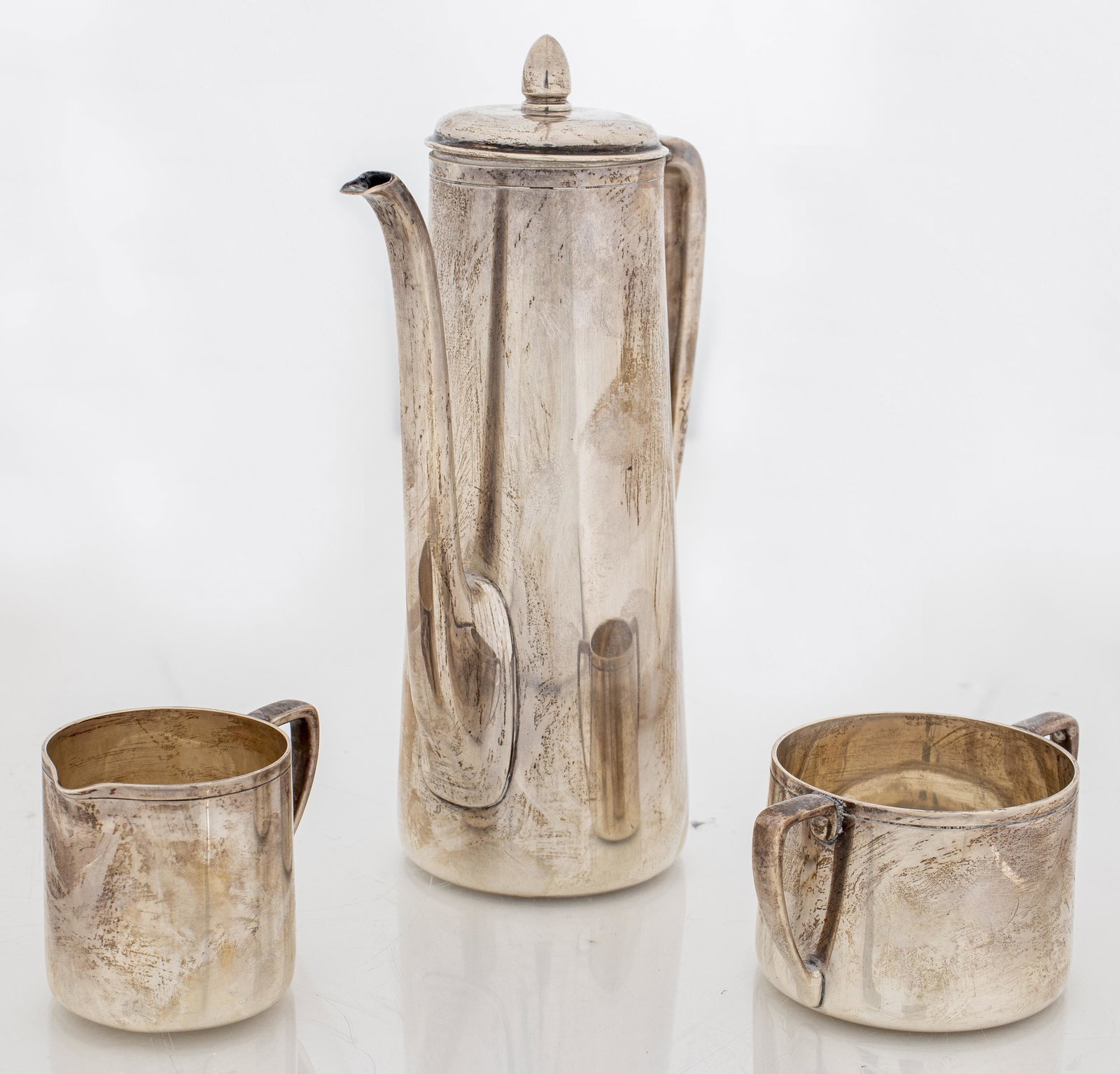 Tiffany & Co. Silver Tea Service, 3 Pieces: Tiffany & Co. sterling silver tea service, three pieces, comprising teapot with bone insulators, sugar bowl, and cream pitcher, all bearing maker's marks underside and numbered "22638." Teapot: 8.5" H