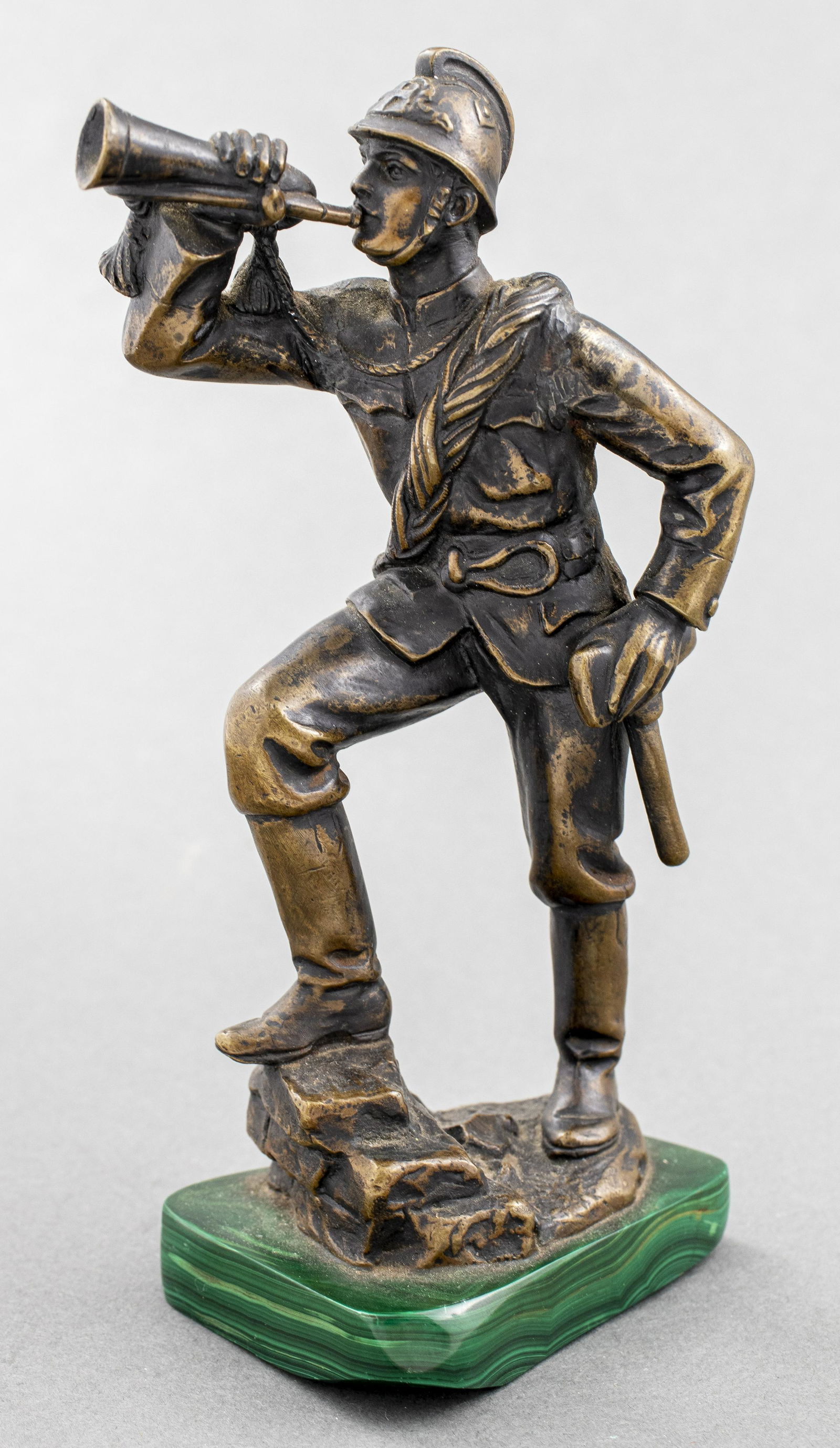 Bronze Model Of A Soldier w Horn On Malachite Base: Bronze model of a soldier blowing a horn on a malachite base, unsigned. 7.25” H x 4” W x 2.75” D