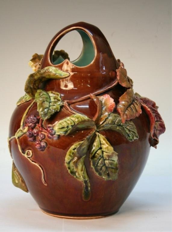 French Sarreguemines Ceramic Vase with Vines: Majolica vase with three openings, a blue interior glaze, and applied leaves and berries, Sarreguemines, ceramic, France, early 1900s; marked on bottom. Dimensions: 10"H x 7" diameter