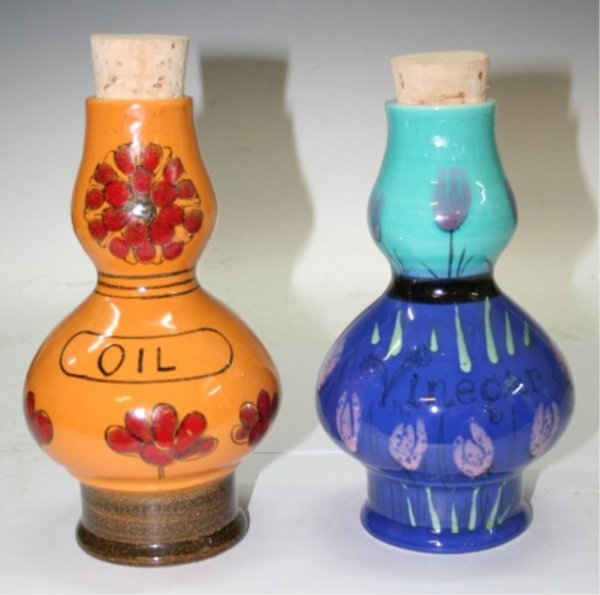 20th C. Raymor Oil and Vinegar Pottery Set: Oil and vinegar set with large cork stoppers. Oil bottle is orange with red flowers and vinegar bottle is blue and turquoise with lilac-colored flowers, by Raymor, ceramic, Italy, twentieth century; m