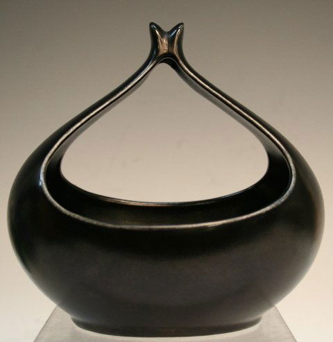Eva Zeisel Black Ceramic Vase: Abstract vase with matte black glaze, by Eva Zeisel, ceramic, America, twentieth century; unmarked. Dimensions: 6-1/2"H x 6-1/2" diameter