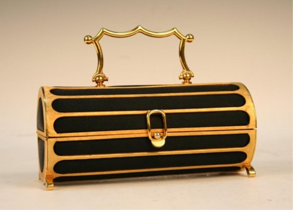 Judith Leiber for Bonwit Teller Satin Handbag: Four-footed, tubular Judith Leiber handbag made for Bonwit Teller line with a hinged lid, carrying handle and satin interior lining, brass and satin, United States; signature and tag on inside of bag.