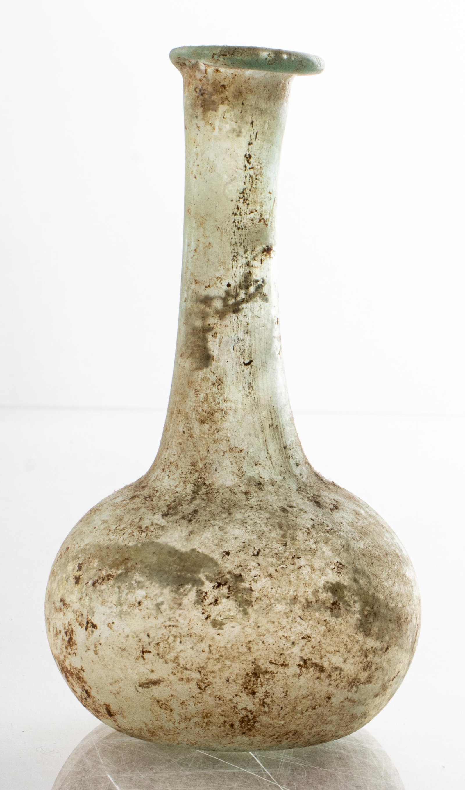 Ancient Roman Glass Unguentarium Bottle: Ancient Roman glass unguentarium or "tears vessel," circa 1st to 3rd century C. E. 3.75" H x 2.125" diameter.