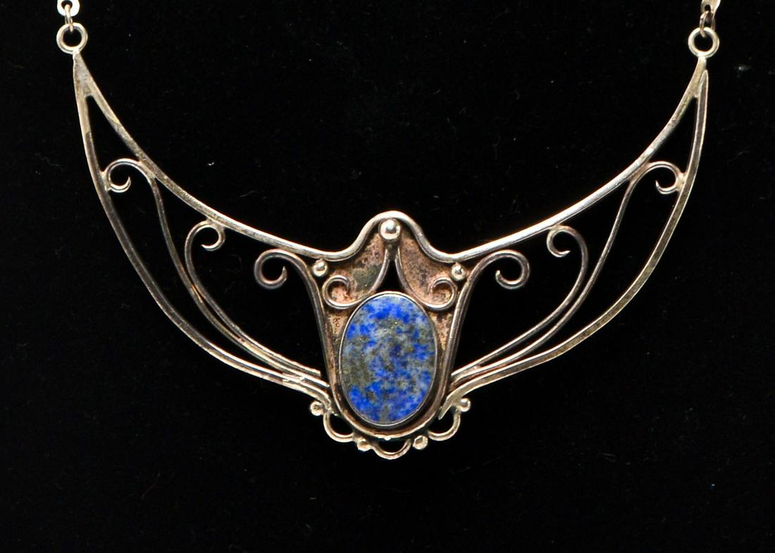 Art Nouveau Style Silver & Lapis Lazuli Necklace: Art Nouveau style silver necklace with oval lapis lazuli. Pendant: 2.5" H x 3.5" W. Approx: 0.64 ozt inclusive; tested silver.