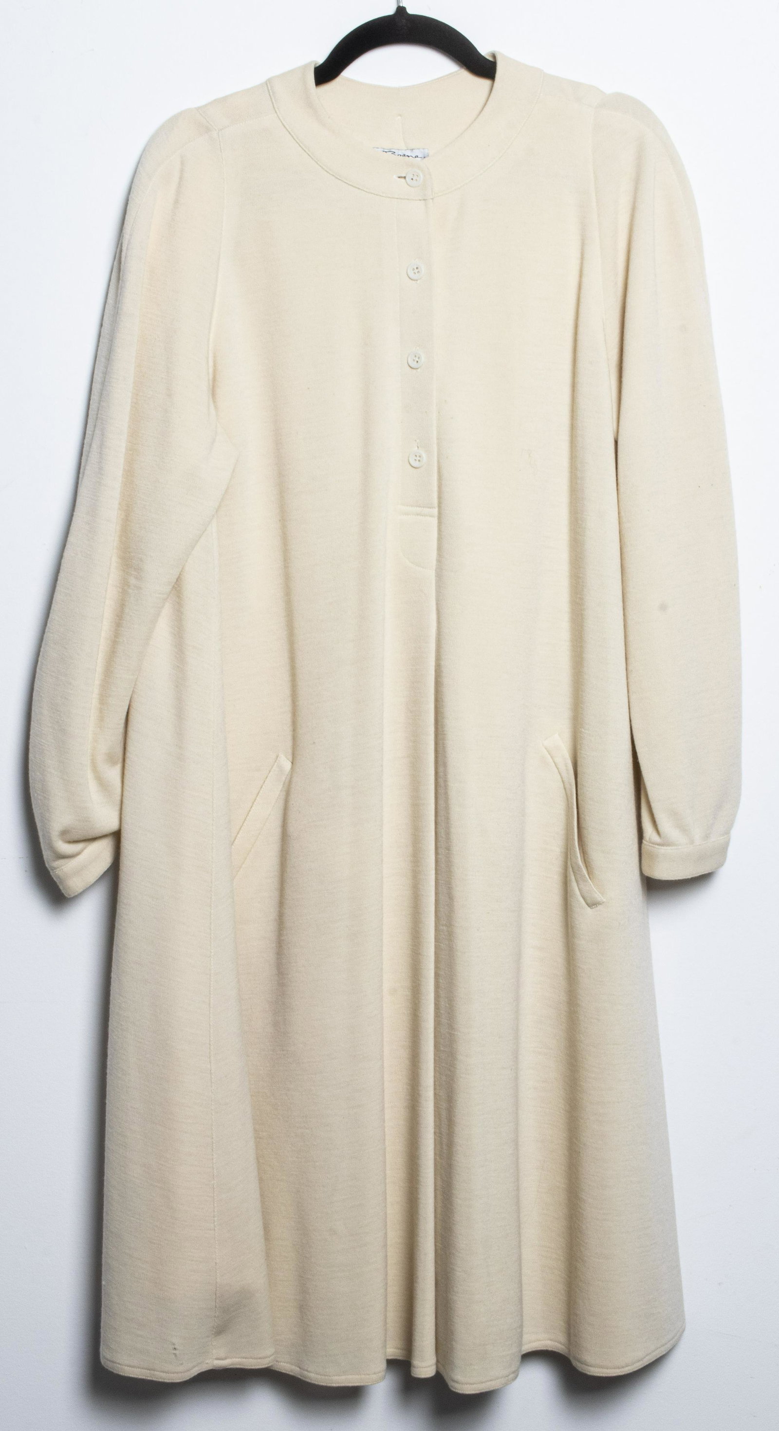 Mr. Beene Geoffrey Beene Wool Dress, Size 14: Vintage Mr. Beene silk-lined, long sleeve, 100% wool cream-colored collarless dress with slit pockets. Approx. length 44", shoulder 26", bust 40", sleeve 25". Minor stains noted.