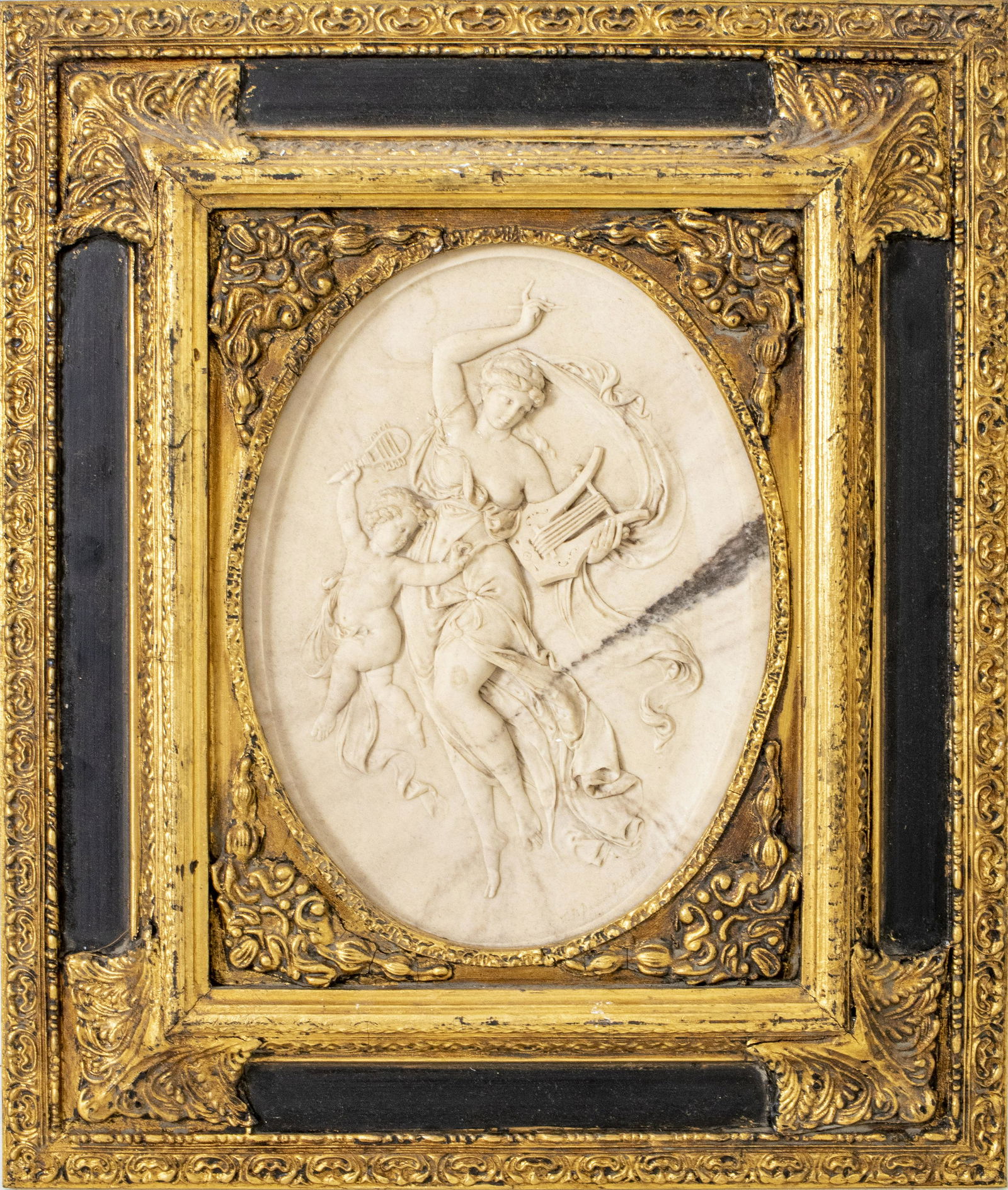 French Oval Carved Marble Relief Plaque: French oval carved marble relief plaque, late 19th century, centered with a scene of a Classical maiden and cherub in billowing robes and holding harps, bears signature lower right, the reverse inset
