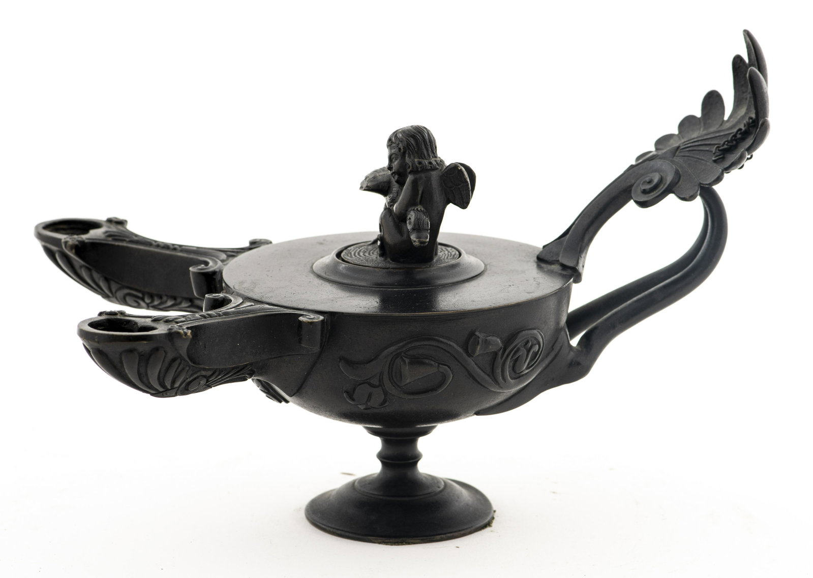 Grand Tour Style Bronze Double Oil Lamp: Grand Tour style bronze double oil lamp, after the antique, the scrolling handle with foliate palmette motif, the lid with cherub and swan detail. 6.25” H x 9.5” diameter. Provenance: Removed from
