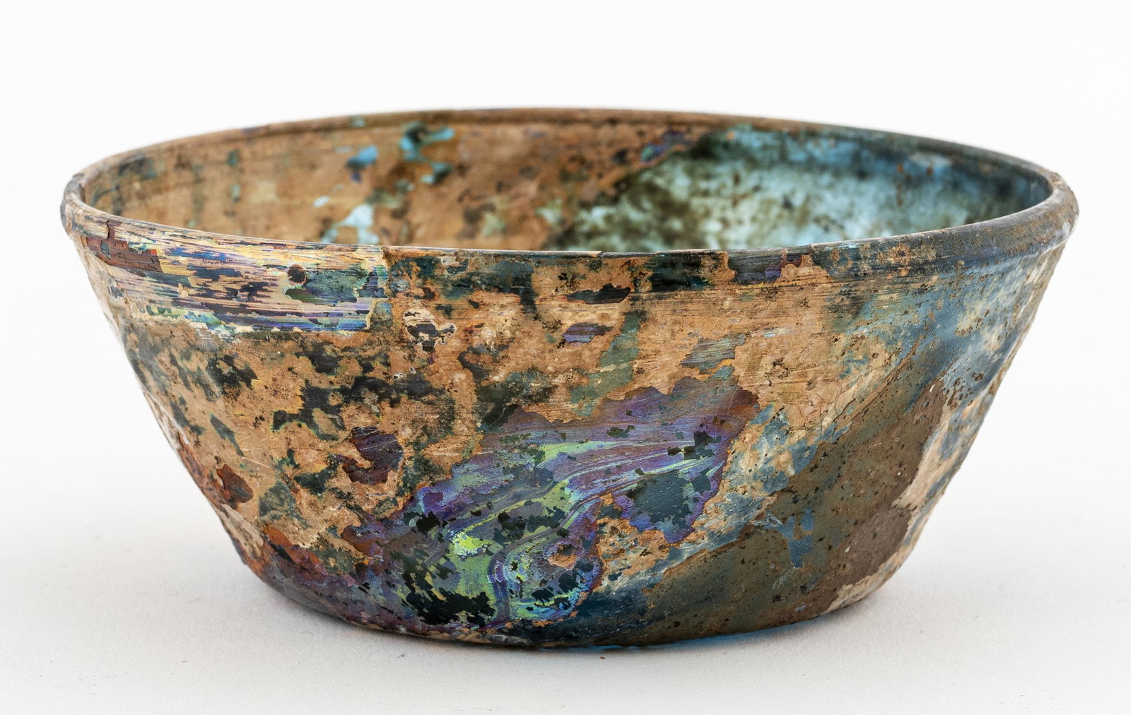 Ancient Islamic Blue Glass Bowl: Ancient Islamic, circa 7th century CE, iridescent glass bowl with flaring sides and hexagon glass molding. 4.375" H. Removed from a 936 5th Avenue estate.