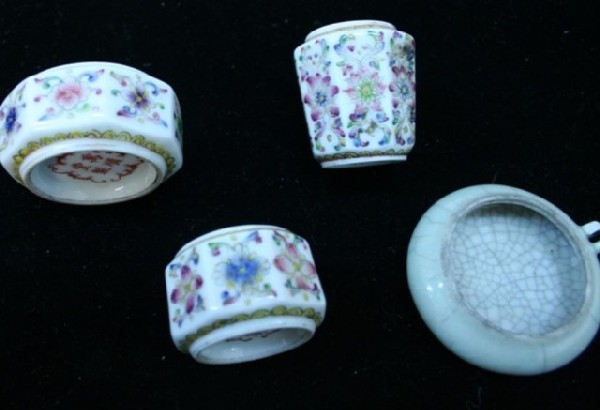 Variety of Four Chinese Porcelain Bird Feeders: Four porcelain bird feeders, three with floral motifs with handles, the other with light green glaze and craquelure throughout, also has handle for hanging, China; marked. Dimensions: Floral 1"L x 2"W