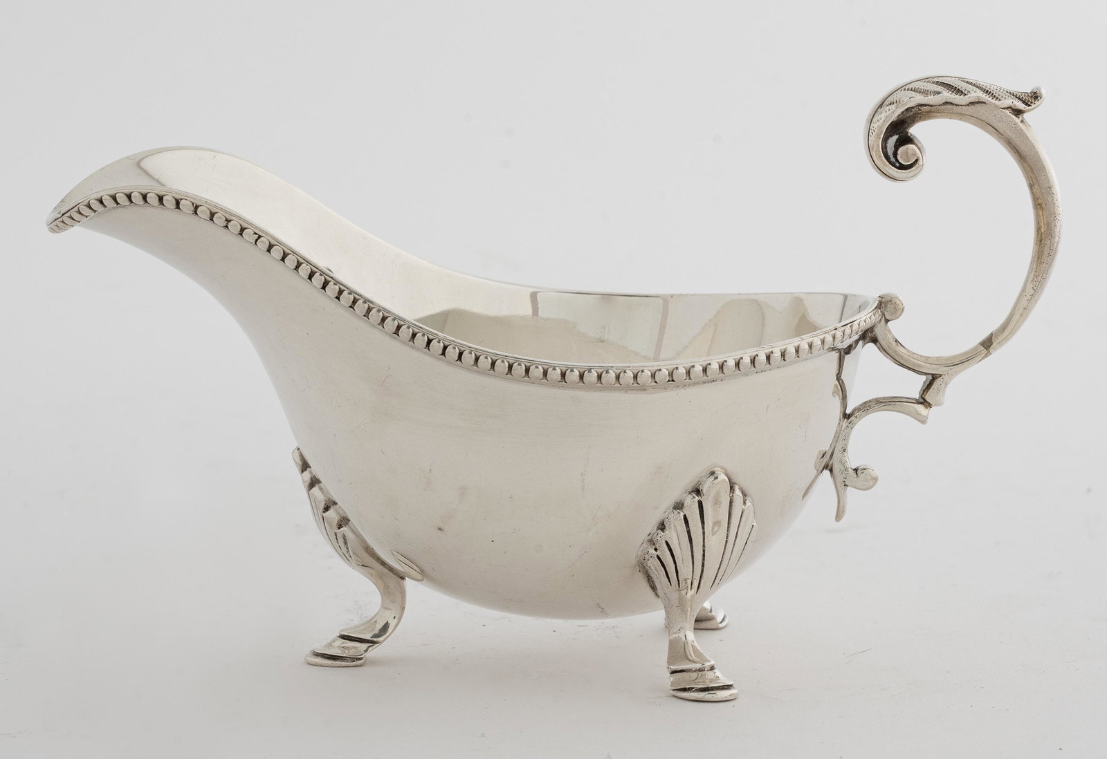 Mappin & Webb English Sterling Silver Gravy Boat: Mappin & Webb, London, small sterling silver gravy boat, marked "Mappin & Webb, London" underside, maker's mark on top rim. 3.25" H x 6.25" L . Approx: 6.01 ozt.
