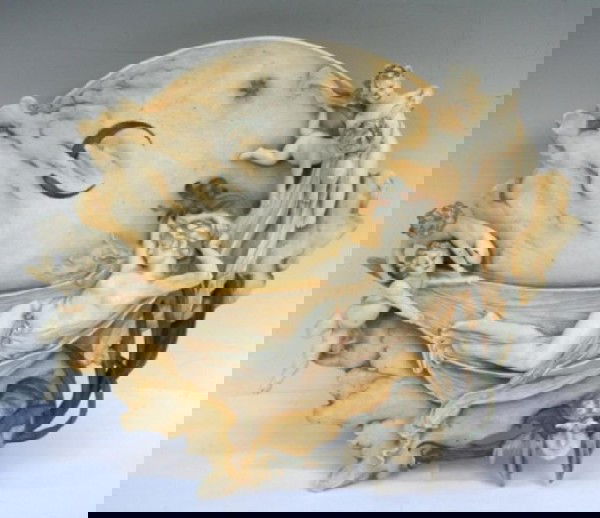 Art Nouveau Ceramic Wall Plaque with Figures: Art Nouveau hanging wall plaque with reclining female nude being carried through the heavens by cherubs and a female face with bat headdress at the bottom, possibly Amphora, ceramic, Bohemia; stamped