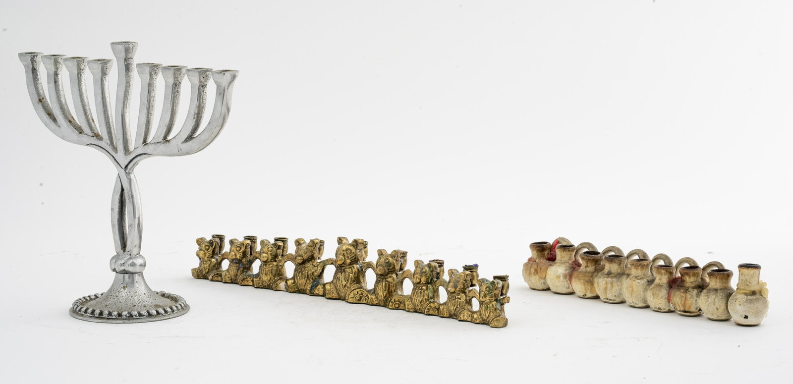 Menorahs, 3: Three Menorahs, brass, ceramic, and metal. 8.5" H x 9" W