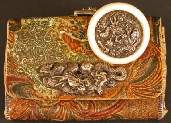 Edo Period Tobacco Pouch with Dragon Netsuke: Leather tobacco pouch (Tabakoire) embossed with colored dragons and an ivory and silver dragon Manju (Kagamibuta Netsuke)attached by silver chains, Japan, Edo Period (1603-1868). The clasp is also a c