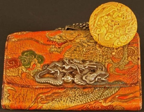 Edo Tobacco Pouch with Dragon Netsuke by Tokutaka: Tangerine-colored leather tabakoire (tobacco pouch) embossed with a large dragon and flowers and bearing a silver clasp with the same motifs. The silver backing to the clasp is adorned with wave desig