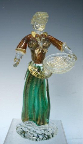 Italian Murano Art Glass Figurine Sculpture: Murano glass art figurine of woman with basket; internally decorated with green and brown core overlaid with heavy gold leaf, Italy; unmarked. Dimensions: 10"L x 5"W x 3-3/4"D