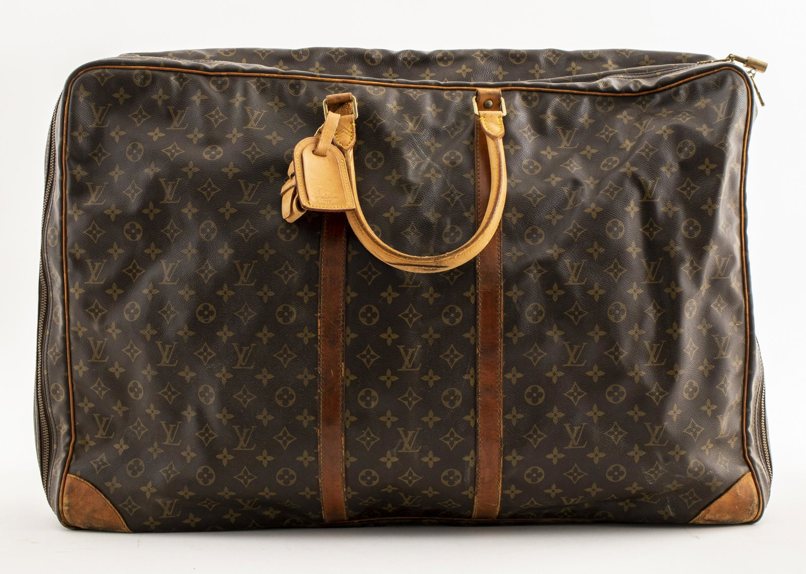 Louis Vuitton "Sirius" Weekend Travel Bag: Louis Vuitton large stamped leather monogram Sirius weekend travel bag, marked "Louis Vuitton Made in France," with leather handle, large interior pocket and elastic straps. 18" H x 26" W x 7" D