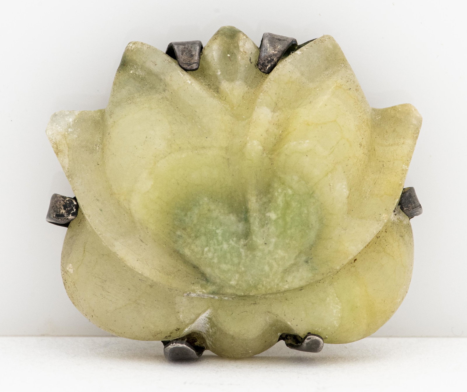 Antique Silver Carved Soapstone Lotus Flower Pin: Antique silver carved soapstone lotus flower motif pin. Pin measures: 1.31"L x 1.12"W x 0.5"H. Silver tested. 0.47 ozt.