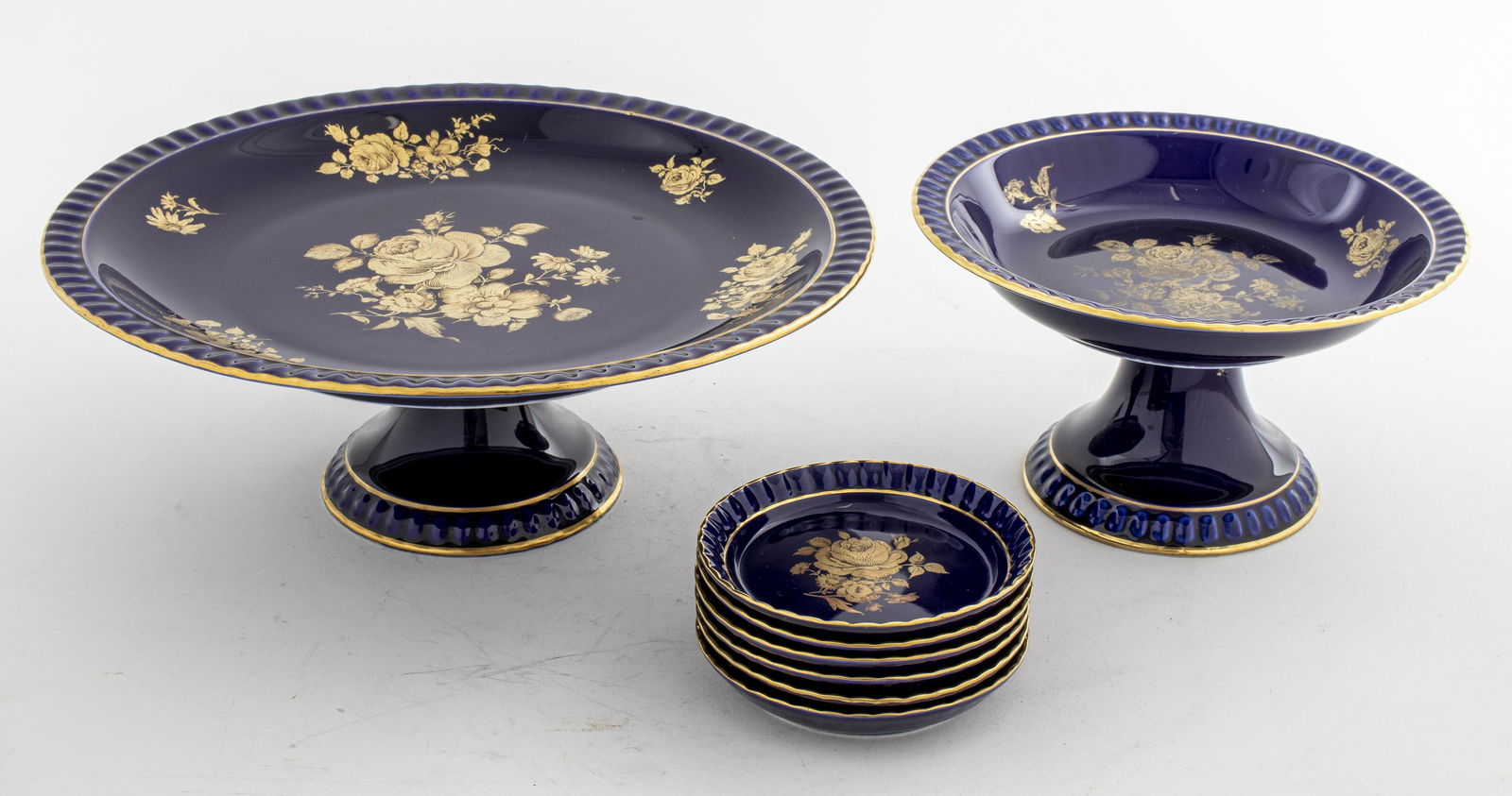 Bareuther Waldgassen Cobalt Blue Serveware: Bareuther Waldgassen Bavaria Germany set of two elevated serving plates or dessert stands and six tea plates in cobalt blue porcelain with gold painted rims and roses. Marked on the bottom. Largest se