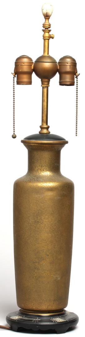 Cassidy Co. Chinese Bangchiuping Vase Lamp: Having a mottled surface of hollow bronzed metal, on a black metal base inset with white plaques displaying Chinese images. Overall: 26" H. Minor scuffing to surface.