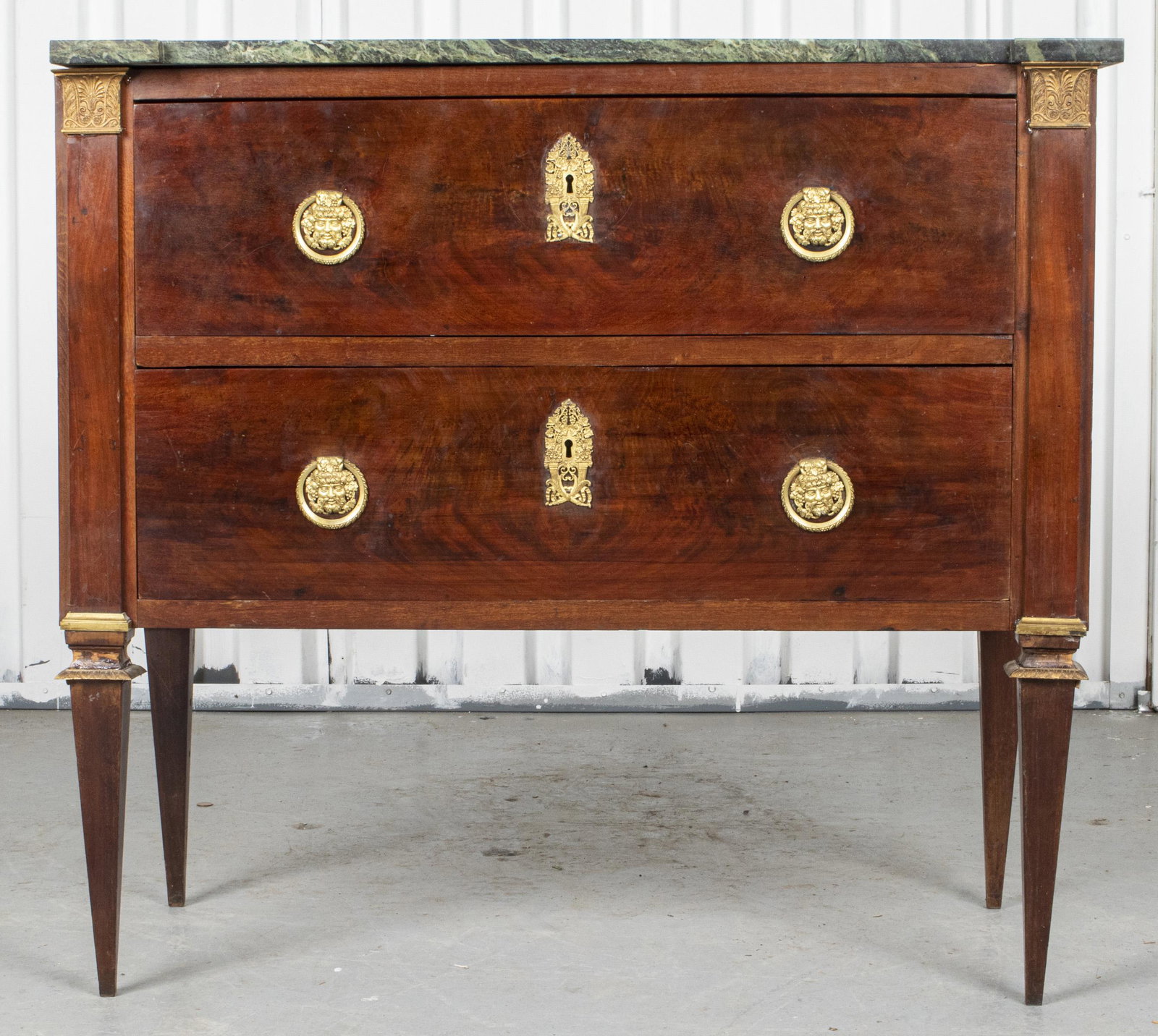 Louis XVI Style Commode With Green Marble Top: Louis XVI style commode with green marble top, the chest with two drawers and raised on tapered square legs. 33.5” H x 36.24” W x 17.5” D