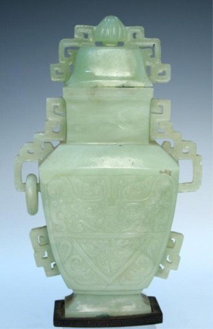Chinese Carved Jade Urn: Carved jade flat bodied urn with lid, geometric openwork handles, low relief with stylised face and animals, China; unmarked. Dimensions: 9"H x 5-1/2"W x 1-3/4"D
