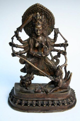 Nepalese Bronze Durga Slaying Mahishasura 19th C.: Figure of Durga slaying the demon Mahishasura as it emerges from a decapitated buffalo, bronze, Nepal, nineteenth century; unmarked. Dimensions: Approximately 7"H x 5-1/8"W x 2-1/2"D