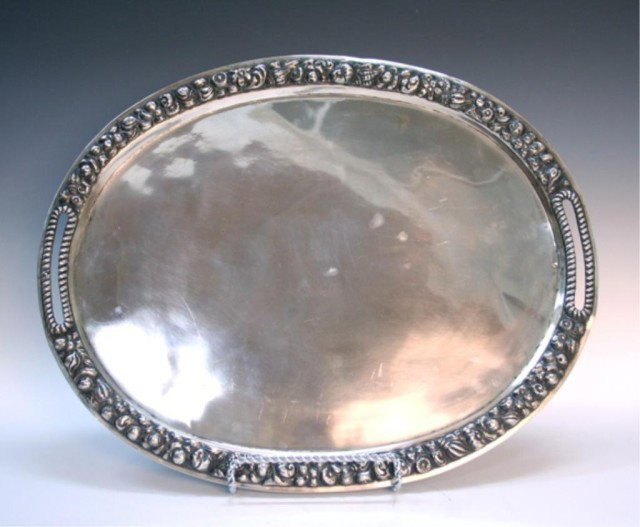Russian Sterling Silver Serving Tray Marked "HF": Oval, recessed serving tray with two cutout handles featuring seashell and floral motifs in repousse around the raised rim, sterling silver, Russia; stamped with a head and "HF" on the interior surfac