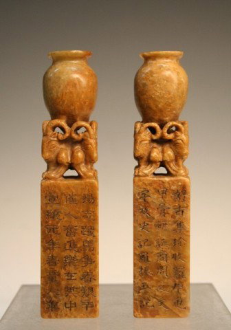 Pair of Chinese Carved Soapstone Seals w/ Rams: Pair of carved seals featuring two jugs supported by six ram's heads atop rectangular prism bases each with calligraphy on one panel, soapstone, China; marked. Dimensions: Each 5-3/4"H x 1-1/8" square