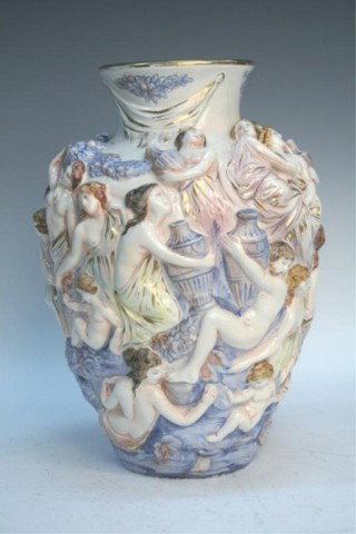 Italian Capo-di-monte Porcelain Figural Vase: Capo-di-monte porcelain classical figure vase decorated in bas relief with gilt base, Italy; marked and numbered. Dimensions: 11-1/8"H x7" diameter