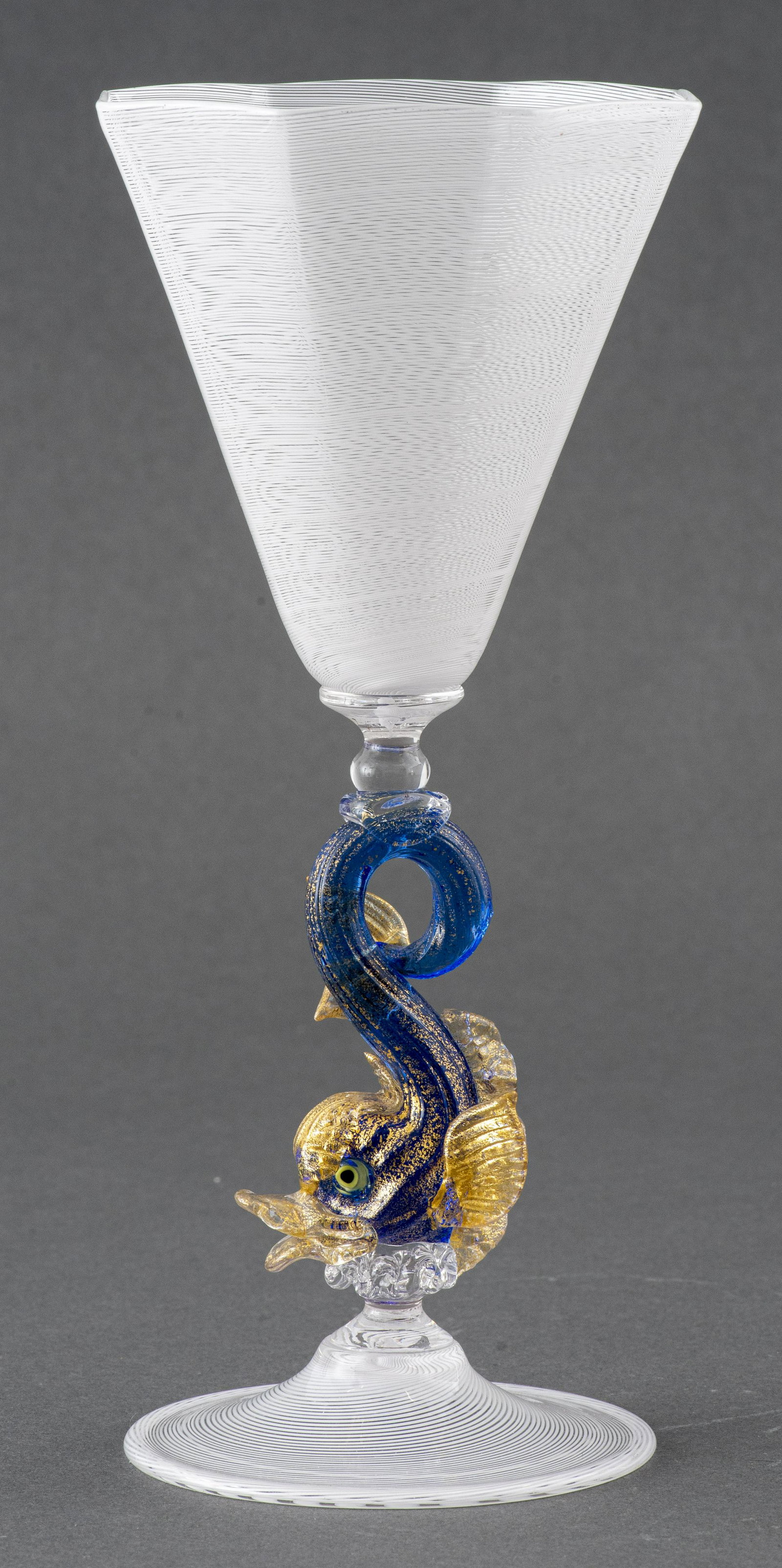 Salviati Venetian Murano Glass Goblet: Salviati Venetian Murano blown glass water or wine goblet with Aventurina 'pasta stellaria' gold-tone flecked dolphin stem detail. 8.5” H x 4” diameter. Provenance: Property removed from t