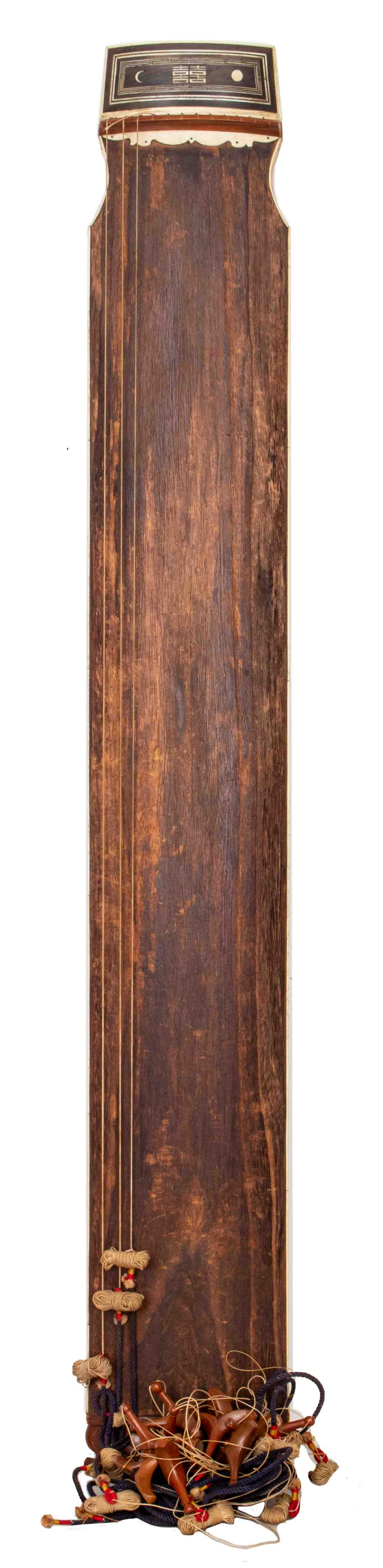 Korean Gayageum Zither Instrument: 12-stringed instrument with bone accents and inlay, sun and moon symbols with "Double Happiness" characters, silk wrapped strings. 56.5" H x 8.5" W x 2.5" D.