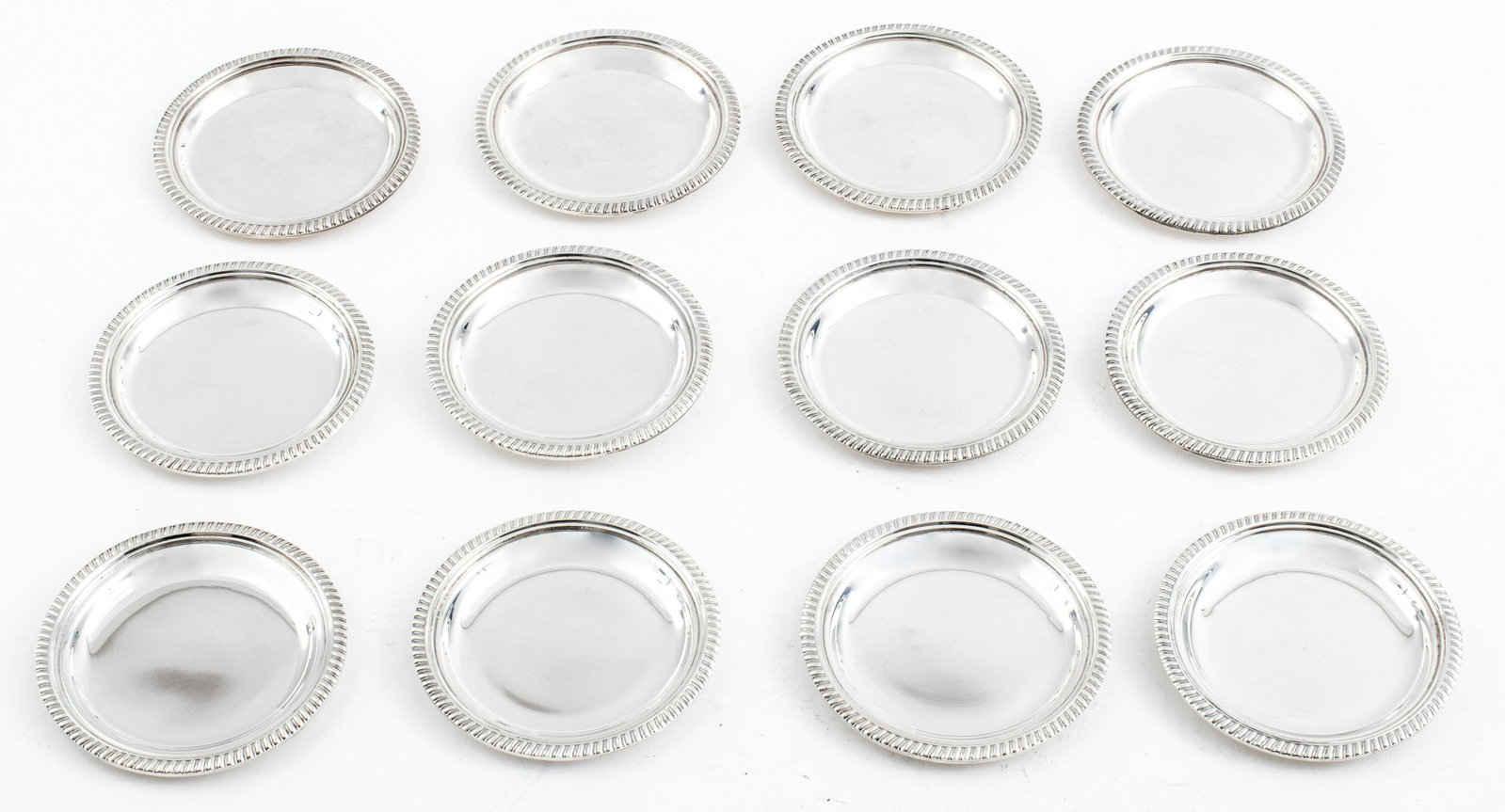 Miracoli Italian Silver Butter Pats, Set of 12: Set of 12 Italian .800 grade silver round butter pats with a gadrooned edge by R Miracoli, marked under the rim. 3.625" in diameter. 25.04 ozt.