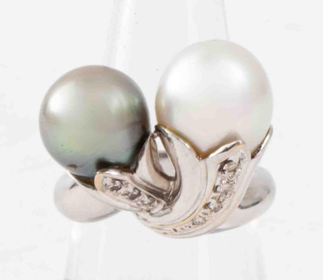 18K Gold South Sea & Tahitian Pearl Diamond Ring: 18K white gold 11.4mm South Sea pearl and 10.8mm Tahitian grey pearl floral intertwine diamond ring, set with seven graduating round brilliant-cut diamonds; approx: 0.12 ctw., marked: "18K". Pears hav