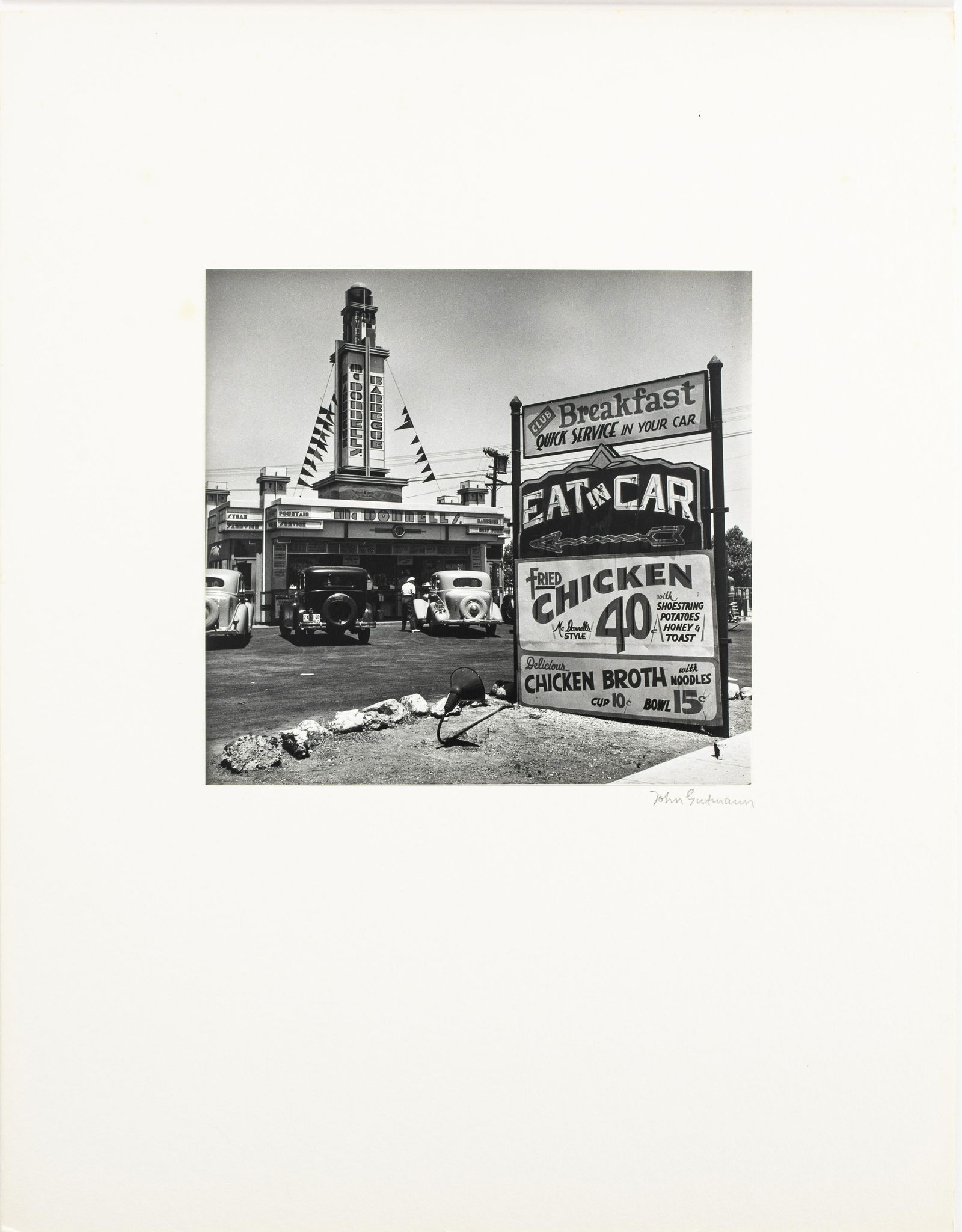 John Gutmann "Eat in Car" Gelatin Silver Print: John Gutmann (German-American, 1905-1998) "'Eat in Car' Early Drive-In Restaurant, Hollywood (187.10)," gelatin silver print, 1935, printed in 1974, signed in pencil on board mount, bearing Martin Z.