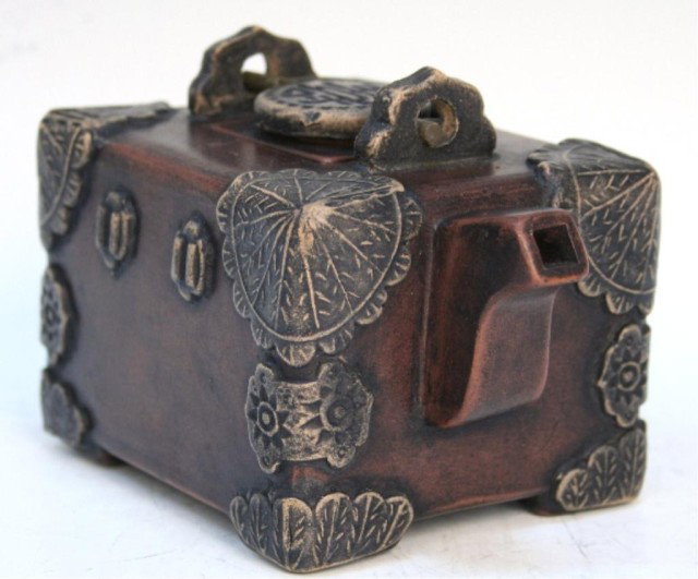 Chinese Yixing Clay Box-Shaped Teapot: Box-shaped teapot with appliques that resemble bronze fittings, Yixing ceramic, China; marked. Dimensions: Approximately 3-3/4"H x 5-1/2"W x 3-3/4"D