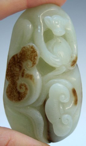 Chinese Carved Jade Monkey Pendant: Small carved jade pendant of monkey perched with flowers, brown inclusions, China; unmarked. Dimensions: 2-5/8"L x 1-5/8"W x 7/8"D
