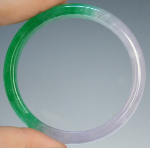 Chinese Transparent Green Jade Bangle: Transparent half green jade bangle, China; unmarked. Dimensions: 3/8"H x 2-3/4" diameter