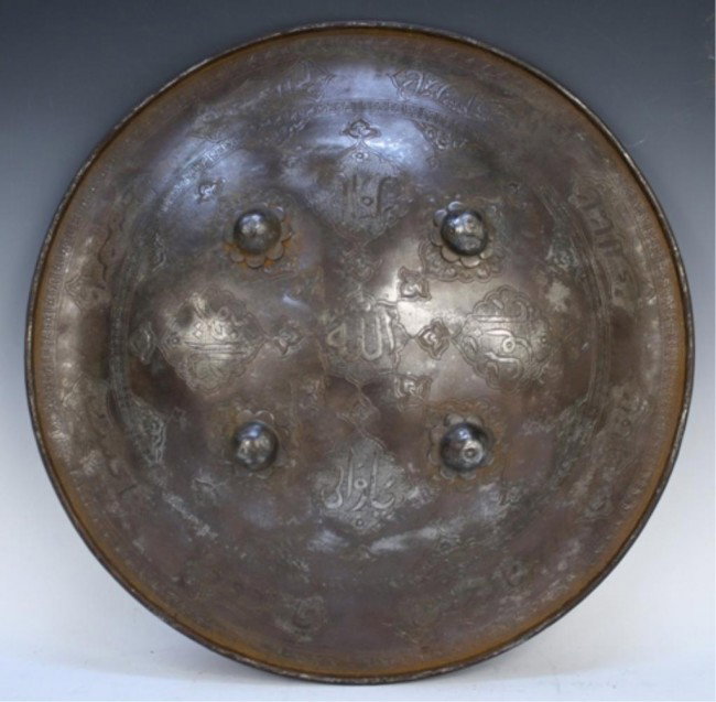 Ottoman Turkish Iron Shield: Round Ottoman Turkish iron shield with engraved Arabic writing, stylized floral designs and four raised roundels, Turkey; unmarked. Dimensions: 16-1/2" diameter.