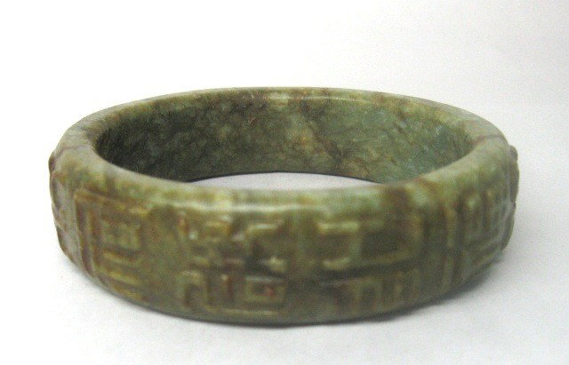 Chinese Carved Jade Bangle Bracelet with Script: Carved jade bangle bracelet with script, China; unmarked. Dimensions: 3-1/4" diameter; 3/4" thick