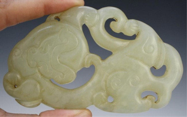 Chinese Openwork Carved Jade Foo Dog: Openwork carved jade foo dog, China; unmarked. Dimensions: 2-3/8"H x 4-1/8"W