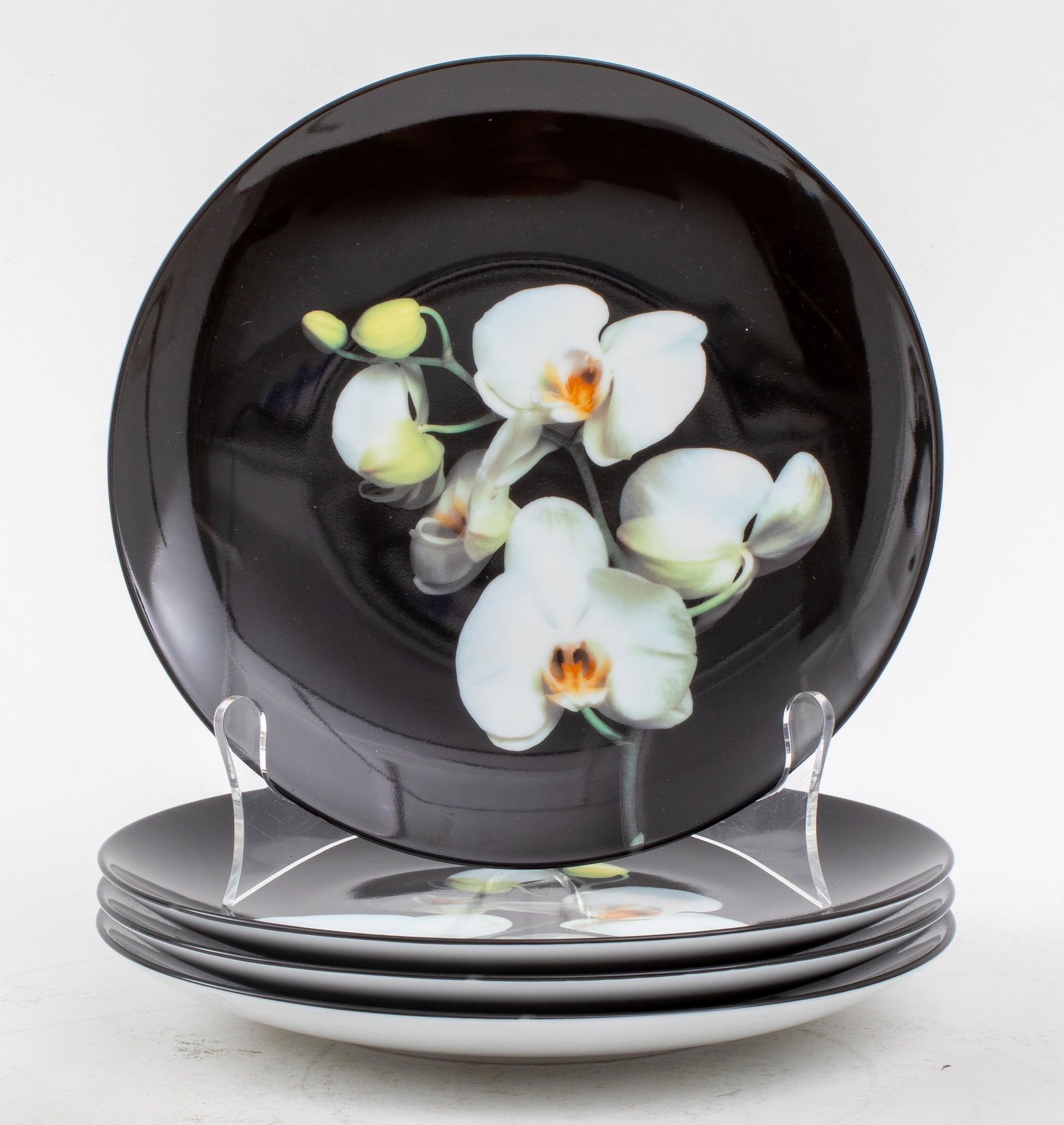 Robert Mapplethorpe for Limoges "Orchid" Plates, 4: Robert Mapplethorpe (American, 1946-1989) by Ligne Blanche for Limoges porcelain plates in the "Orchid" design on a black ground, all marked to undersides. 8.25" diameter.