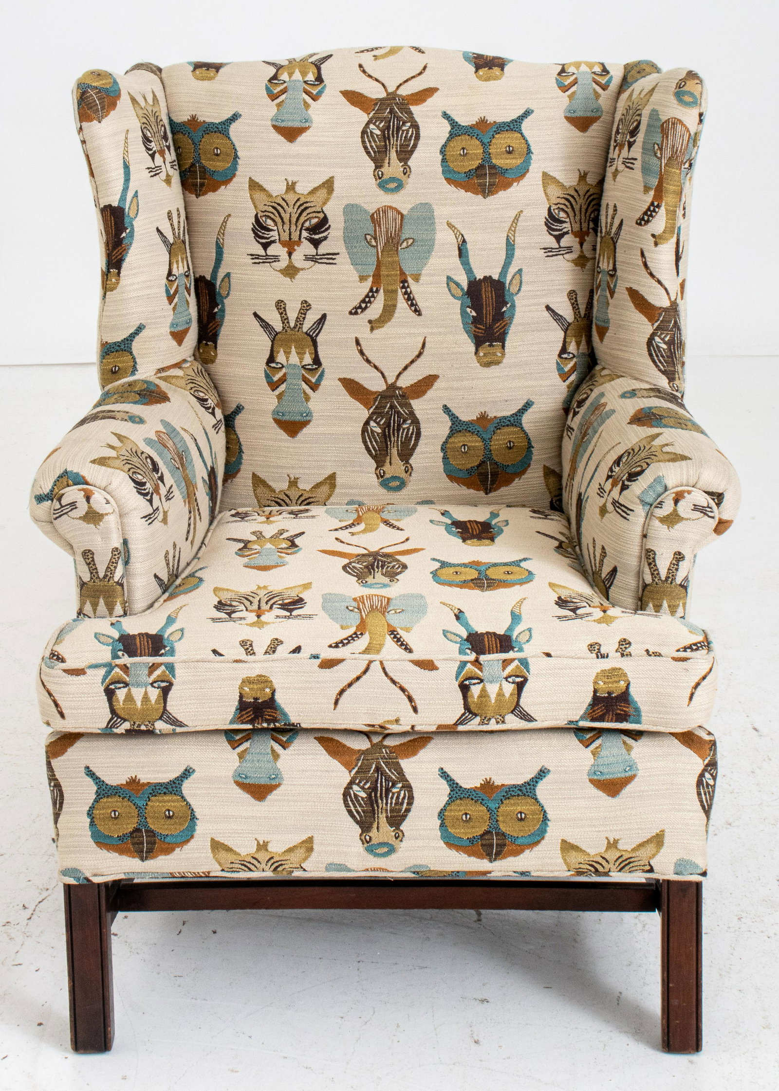 Classical 'Animal Trophy' Wingback Armchair: Classical wingback armchair with animal trophy textile upholstery and carved wooden legs. 38" H x 30" W x 35" D. Seat 18" H.