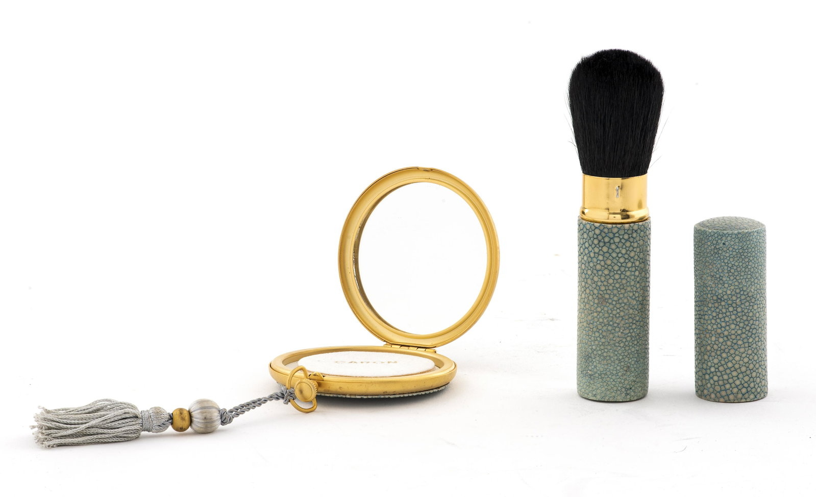 Caron Faux Shagreen Compact and Brush: Caron Faux shagreen compact and brush, manufactured by the French company â€œParfums Caron” (est. Paris, 1904, appear to date from the 1990s or later. The compact has a mirror, powderpuff, a