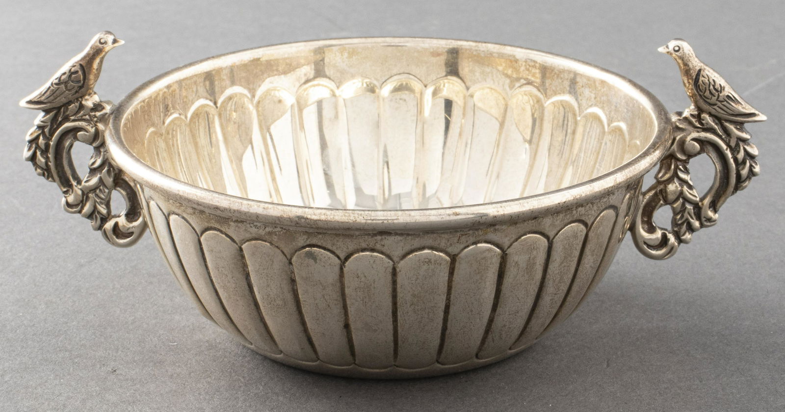 Tane Orfebres Mexican Silver Bird Handle Dish: Tane Orfebres, Mexico City, Mexican sterling silver dish with bird motif handles, marked "Tane / MT01 / Mexico / 925." 2" H x 5" diameter (handle to handle). Weighs 3.86 ozt.